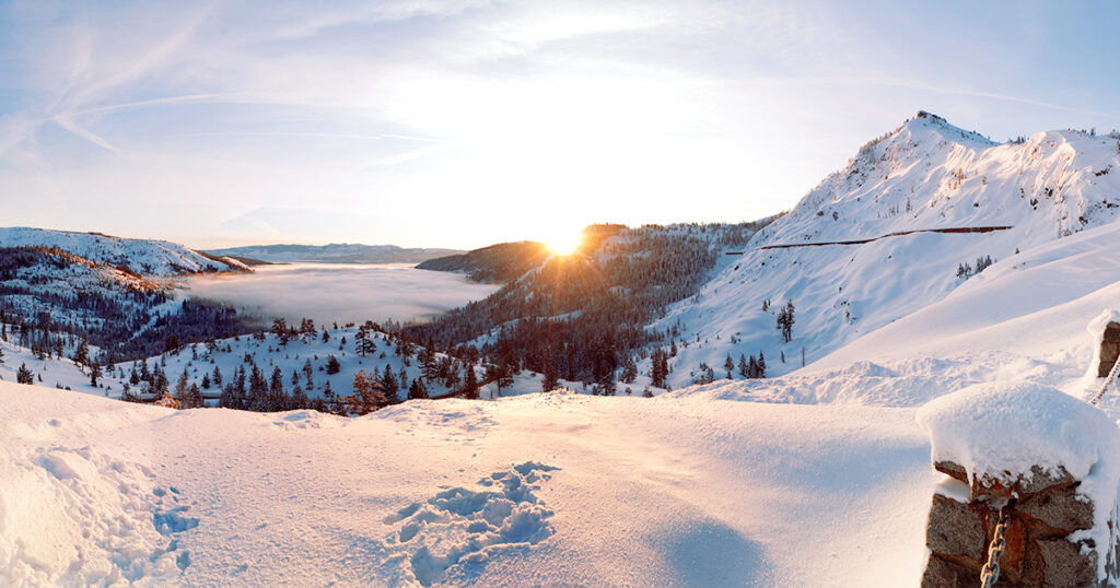 Snowy view of Donner Lake at sunrise